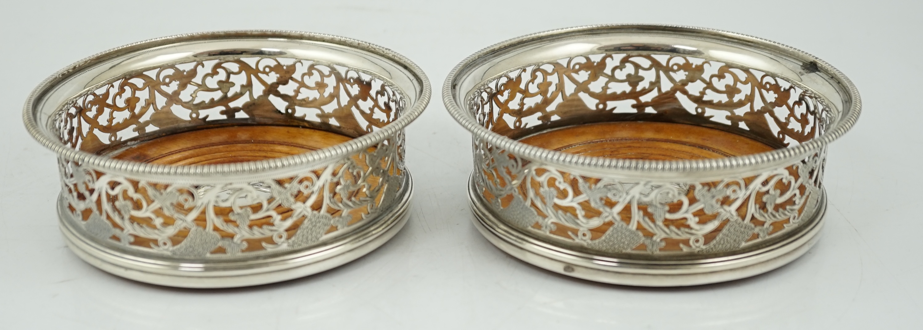 A pair of George III pierced silver mounted wine coasters, William Allen III